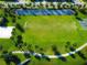 Aerial view of soccer field and basketball court within community green space with walking paths and palm trees at 1624 Tropical Palms Cir, Kissimmee, FL 34747