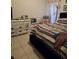 Cozy bedroom featuring a striped bedspread and white dresser at 1639 Nestlewood Trl, Orlando, FL 32837