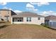 Back exterior of home featuring a grassy lawn at 1830 Juneberry St, Clermont, FL 34715