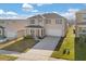 Charming two-story home with a well-manicured lawn and a two-car garage at 1830 Juneberry St, Clermont, FL 34715
