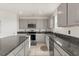 Kitchen features gray cabinets, granite countertops, and stainless steel appliances at 1830 Juneberry St, Clermont, FL 34715