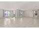 Open living room featuring large windows providing ample natural light and tile flooring at 1830 Juneberry St, Clermont, FL 34715