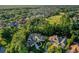 Aerial view of a luxury home surrounded by lush trees and a golf course at 1906 Oakbrook Dr, Longwood, FL 32779