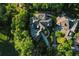 Secluded estate features a private pool, meticulously manicured grounds, and a serene wooded backdrop at 1906 Oakbrook Dr, Longwood, FL 32779
