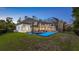 Spacious backyard featuring a private basketball court and a screened pool area for year-round enjoyment at 1906 Oakbrook Dr, Longwood, FL 32779