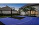 Backyard basketball court offers a fun recreational amenity surrounded by lush landscaping and privacy at 1906 Oakbrook Dr, Longwood, FL 32779