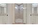 Modern bathroom with a glass enclosed shower between two vanities with large mirrors at 1906 Oakbrook Dr, Longwood, FL 32779