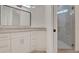 Bright bathroom featuring a modern vanity with a stone countertop and a glass-enclosed shower at 1906 Oakbrook Dr, Longwood, FL 32779