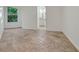 Bright bedroom with neutral tile flooring and abundant natural light from a large window overlooking trees at 1906 Oakbrook Dr, Longwood, FL 32779