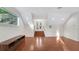 Bonus room with hardwood floors, white trim, and staircase leading up to the French doors at 1906 Oakbrook Dr, Longwood, FL 32779