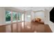 Versatile bonus room with hardwood floors, access to an outdoor balcony, and a cozy seating area at 1906 Oakbrook Dr, Longwood, FL 32779