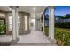 Covered porch featuring stately pillars, architectural windows, and brick accents at 1906 Oakbrook Dr, Longwood, FL 32779