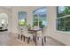 Elegant dining room with large windows and comfortable seating for four at 1906 Oakbrook Dr, Longwood, FL 32779