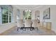 Elegant dining room with large windows, decorative chandelier, and seating for six at 1906 Oakbrook Dr, Longwood, FL 32779