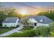 Beautiful home exterior with mature landscaping, tiled roof, and inviting driveway at sunset at 1906 Oakbrook Dr, Longwood, FL 32779