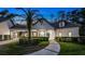 Stunning home exterior with lush landscaping and elegant architectural details at twilight at 1906 Oakbrook Dr, Longwood, FL 32779