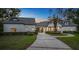 Beautiful home with a tile roof, elegant facade, mature trees and manicured landscaping at 1906 Oakbrook Dr, Longwood, FL 32779