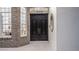 Elegant double front door flanked by sidelight windows and brick facade at 1906 Oakbrook Dr, Longwood, FL 32779