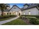 Elegant home with stately pillars, arched entryways, and professionally landscaped grounds at 1906 Oakbrook Dr, Longwood, FL 32779