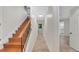 Hallway view with hardwood stairs with wrought iron railing and tile flooring at 1906 Oakbrook Dr, Longwood, FL 32779