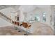 Kitchen island with seating, white cabinets and countertops, stone floors and a staircase at 1906 Oakbrook Dr, Longwood, FL 32779