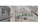 Bright kitchen with stainless appliances, white cabinets, stone floors, and large windows at 1906 Oakbrook Dr, Longwood, FL 32779
