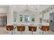 Kitchen island with seating, white cabinets and countertops, stainless appliances and stone floors at 1906 Oakbrook Dr, Longwood, FL 32779