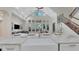 Bright, open-concept kitchen with white cabinetry, large farmhouse sink, and views into the living area with soaring ceilings at 1906 Oakbrook Dr, Longwood, FL 32779