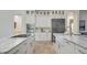 Kitchen featuring a double island, stainless appliances, white cabinets and stone floors at 1906 Oakbrook Dr, Longwood, FL 32779