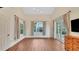 Bright living room with hardwood floors, neutral colors, and large windows at 1906 Oakbrook Dr, Longwood, FL 32779