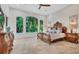 Spacious main bedroom featuring large windows offering picturesque views and a decorative wooden bed frame at 1906 Oakbrook Dr, Longwood, FL 32779