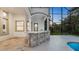 Outdoor kitchen with a stone bar area and a view of the backyard at 1906 Oakbrook Dr, Longwood, FL 32779