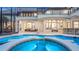 Luxurious outdoor pool with screened lanai, integrated spa, and a stone bar area for entertaining at 1906 Oakbrook Dr, Longwood, FL 32779