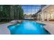 Beautifully designed screened pool area with waterfall features and lush landscaping creating a private oasis at 1906 Oakbrook Dr, Longwood, FL 32779