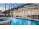 Stunning screened pool with spa, stepping stones, and outdoor living area, perfect for entertaining at 1906 Oakbrook Dr, Longwood, FL 32779