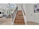 Elegant staircase with wood and tile steps, iron railing, and views of the living area at 1906 Oakbrook Dr, Longwood, FL 32779