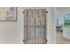 View of decorative wrought iron wine cellar doors and the kitchen beyond at 1906 Oakbrook Dr, Longwood, FL 32779