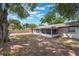 View of the yard featuring a screened-in porch, a fence, and mature trees at 1912 Wyandotte Trl, Casselberry, FL 32707