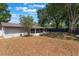 Spacious backyard featuring mature trees, a screened-in porch, and a privacy fence at 1912 Wyandotte Trl, Casselberry, FL 32707