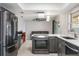 Kitchen boasts stainless steel appliances, gray cabinetry, quartz counters, tile backsplash, and center island at 1912 Wyandotte Trl, Casselberry, FL 32707