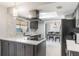 The kitchen features stainless appliances, gray cabinetry, quartz counters, and easy access to dining area at 1912 Wyandotte Trl, Casselberry, FL 32707