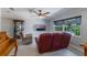 Well-lit living room featuring stylish flooring, comfortable seating, and a modern display cabinet at 1912 Wyandotte Trl, Casselberry, FL 32707
