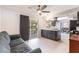 Living room view to the modern kitchen featuring stainless appliances and gray cabinets at 1912 Wyandotte Trl, Casselberry, FL 32707