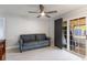 The living area features a modern ceiling fan, wood flooring, and sliding glass door at 1912 Wyandotte Trl, Casselberry, FL 32707