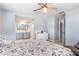 Stylish main bedroom features an ensuite bathroom and ceiling fan at 1912 Wyandotte Trl, Casselberry, FL 32707