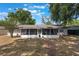 Rear view of the home showcasing an enclosed screened-in porch that offers outdoor living at 1912 Wyandotte Trl, Casselberry, FL 32707