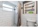 Walk-in shower features white subway tiles and convenient built-in shelving at 1912 Wyandotte Trl, Casselberry, FL 32707