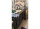 Bathroom vanity features dark cabinets, a granite countertop, and a vessel sink with fixtures at 20 Water Trak, Ocala, FL 34472