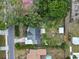 Birds-eye view showing a neatly landscaped yard, storage shed and the home's proximity to the street at 207 Rose St, Auburndale, FL 33823