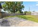 Large backyard with mature trees, storage shed, a concrete patio and a wooden fence at 207 Rose St, Auburndale, FL 33823